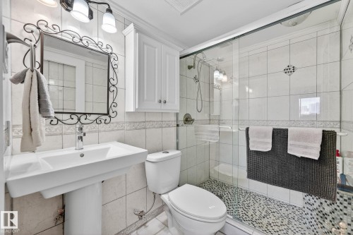Bathroom with a stall shower and tile walls - 1502 10160 115 Street, Edmonton, AB - Indoor Photo Showing Bathroom