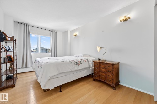 Bedroom featuring light wood-style flooring and baseboard heating - 1502 10160 115 Street, Edmonton, AB - Indoor Photo Showing Bedroom