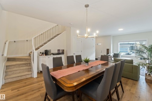 Dining room with light wood-type flooring and hanging lights - 72 Penn Place, Spruce Grove, AB - Indoor Photo Showing Dining Room