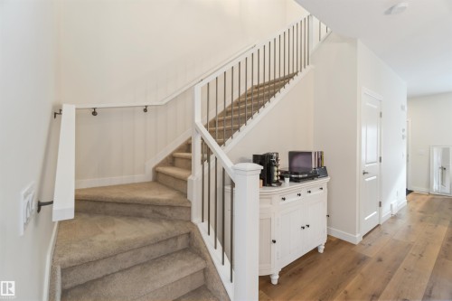 Staircase featuring hardwood / wood-style floors and baseboards - 72 Penn Place, Spruce Grove, AB - Indoor Photo Showing Other Room