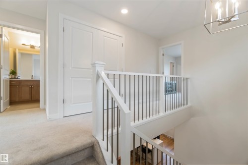 Hall featuring an upstairs landing and hanging lights - 72 Penn Place, Spruce Grove, AB - Indoor Photo Showing Other Room