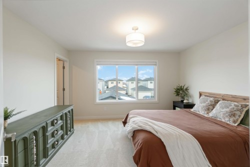 Bedroom with light colored carpet and baseboards - 72 Penn Place, Spruce Grove, AB - Indoor Photo Showing Bedroom