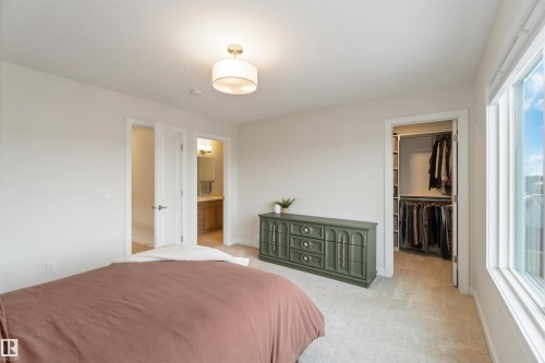 Bedroom featuring a spacious closet and light carpet - 72 Penn Place, Spruce Grove, AB - Indoor Photo Showing Bedroom