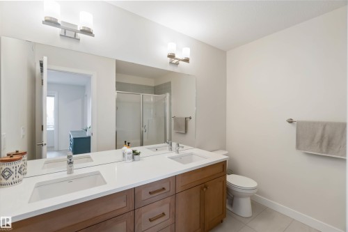 Full bathroom featuring a stall shower, double vanity, and light tile patterned flooring - 72 Penn Place, Spruce Grove, AB - Indoor Photo Showing Bathroom