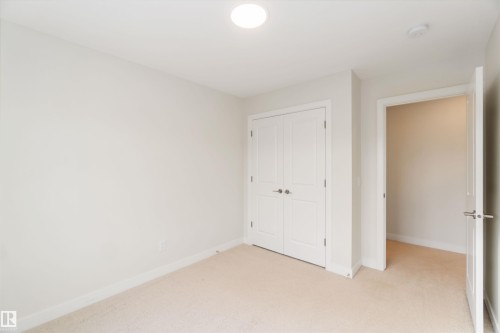 Unfurnished bedroom with light carpet and a closet - 72 Penn Place, Spruce Grove, AB - Indoor Photo Showing Other Room