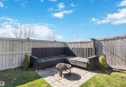 Fenced backyard featuring a patio and a fire pit - 