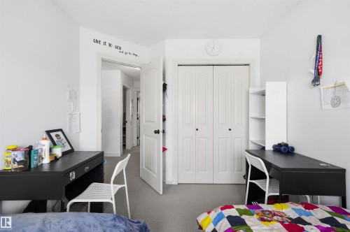 Bedroom featuring a closet and dark colored carpet - 1965 118 Street, Edmonton, AB - Indoor Photo Showing Bedroom