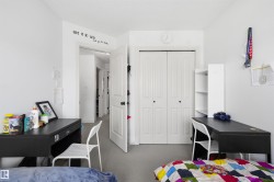 Bedroom featuring a closet and dark colored carpet - 