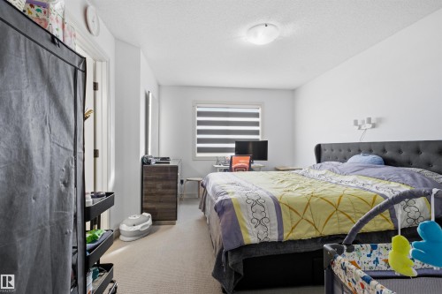 Bedroom featuring light carpet and a textured ceiling - 1965 118 Street, Edmonton, AB - Indoor Photo Showing Bedroom