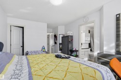 Bedroom with ensuite bathroom, a heating unit, a textured ceiling, and a closet - 