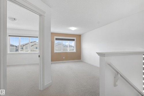 Hall with light carpet and an upstairs landing - 1965 118 Street, Edmonton, AB - Indoor Photo Showing Other Room