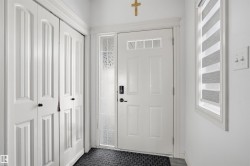 Doorway to outside featuring baseboards - 