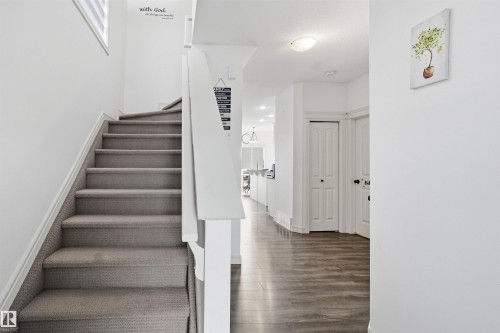 Stairs featuring baseboards and wood finished floors - 1965 118 Street, Edmonton, AB - Indoor Photo Showing Other Room