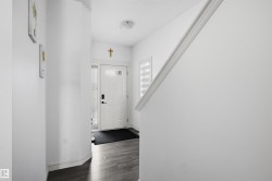 Entryway featuring dark wood finished floors and a textured ceiling - 