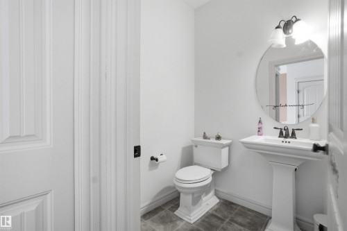 Bathroom featuring toilet and dark tile patterned floors - 1965 118 Street, Edmonton, AB - Indoor Photo Showing Bathroom