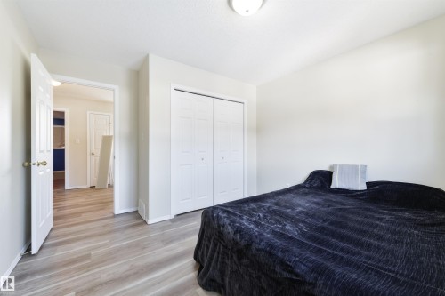 Bedroom featuring light wood-style flooring and a closet - 11522 128 Street, Edmonton, AB - Indoor Photo Showing Bedroom