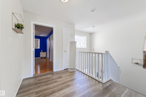 Hallway featuring light wood-style flooring and a textured ceiling - 11522 128 Street, Edmonton, AB - Indoor Photo Showing Other Room