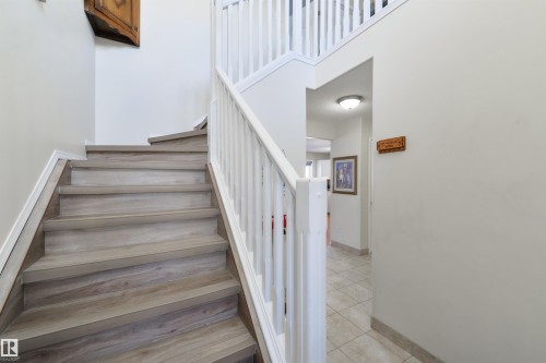 Staircase featuring baseboards and tile patterned flooring - 11522 128 Street, Edmonton, AB - Indoor Photo Showing Other Room