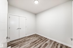 Unfurnished bedroom with wood finished floors and a closet - 