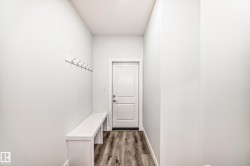 Mudroom featuring dark wood-type flooring and baseboards - 