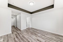 Unfurnished room with a raised ceiling and light wood-type flooring - 