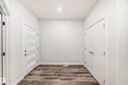 Doorway with wood finished floors and baseboards - 