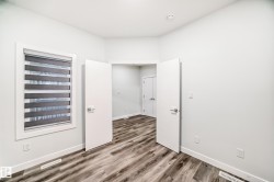 Unfurnished room featuring wood finished floors and baseboards - 