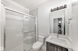 Bathroom featuring vanity and a shower stall - 