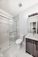 Bathroom featuring vanity and a shower stall - 