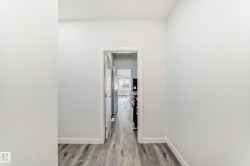Hallway featuring baseboards and light wood-style flooring - 