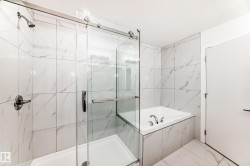 Full bath featuring a bath, a marble finish shower, a textured ceiling, and marble look tiles - 