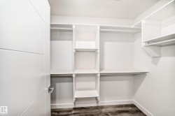 Spacious closet featuring dark wood finished floors - 