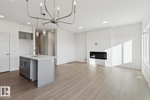 41 Sumac Close, Fort Saskatchewan, AB - Indoor Photo Showing Kitchen With Fireplace