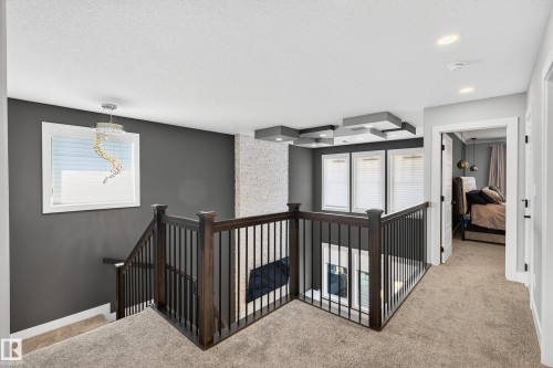 Soaring living room ceilings radiate with natural light to the 2nd floor - 3912 Ginsburg Crescent, Edmonton, AB - Indoor Photo Showing Other Room