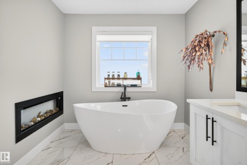 Enjoy long luxurious baths in your incredible soaker tub by the fireplace - 3912 Ginsburg Crescent, Edmonton, AB - Indoor Photo Showing Bathroom