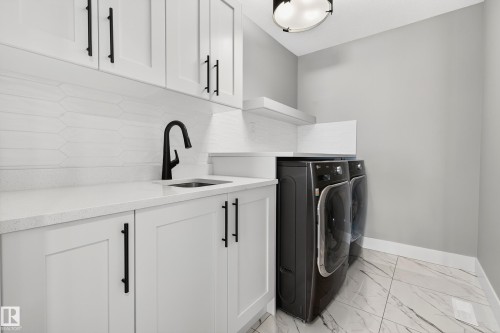 2nd floor laundry with sink and enclosed shelving - 3912 Ginsburg Crescent, Edmonton, AB - Indoor Photo Showing Laundry Room