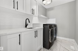 2nd floor laundry with sink and enclosed shelving - 