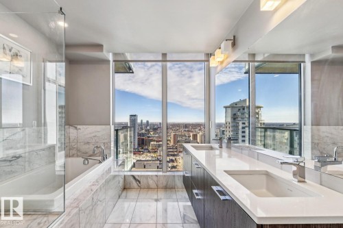 Bathroom featuring a city view, double vanity, and a garden tub - 3300 10180 103 Street, Edmonton, AB - Indoor Photo Showing Other Room