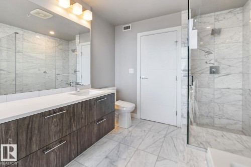 Full bath with vanity, light marble finish flooring, and a marble finish shower - 3300 10180 103 Street, Edmonton, AB - Indoor Photo Showing Bathroom