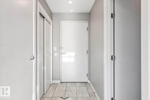 Doorway featuring marble look tiles and recessed lighting - 3300 10180 103 Street, Edmonton, AB - Indoor Photo Showing Other Room