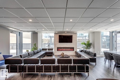 Lobby with a paneled ceiling and recessed lighting - 3300 10180 103 Street, Edmonton, AB - Indoor Photo Showing Living Room With Fireplace