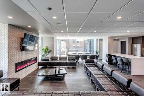 Building lobby with recessed lighting - 3300 10180 103 Street, Edmonton, AB - Indoor With Fireplace