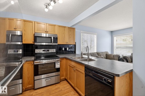 108 150 Edwards Drive, Edmonton, AB - Indoor Photo Showing Kitchen With Double Sink