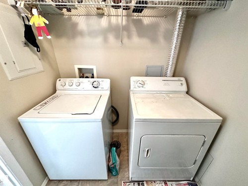 Laundry area with electric panel and washer and clothes dryer - 215 13625 34 Street, Edmonton, AB - Indoor Photo Showing Laundry Room