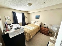 Carpeted bedroom with a textured ceiling - 