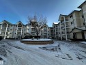 Snow covered building featuring a view of apartment building / complex - 215 13625 34 Street, Edmonton, AB  - Outdoor With Balcony With Facade 
