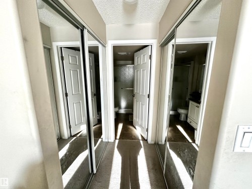 Corridor with a textured ceiling - 215 13625 34 Street, Edmonton, AB - Indoor Photo Showing Other Room
