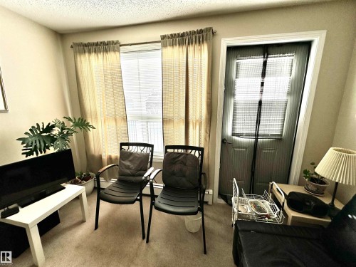 Sitting room featuring carpet and a textured ceiling - 215 13625 34 Street, Edmonton, AB - Indoor