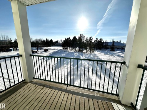 View of snow covered back of property - 215 13625 34 Street, Edmonton, AB - Outdoor With Balcony