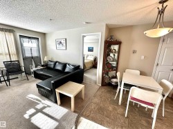 Carpeted living area featuring a textured ceiling - 